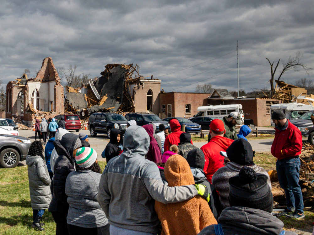 survivors surveying the damage after a tornado in Birmingham, AL