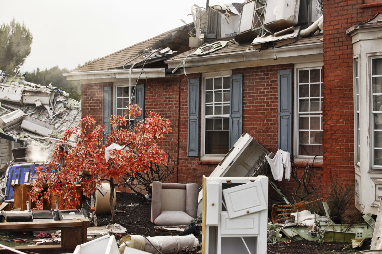 Brick home in Alabama damaged by a tornado and debris.