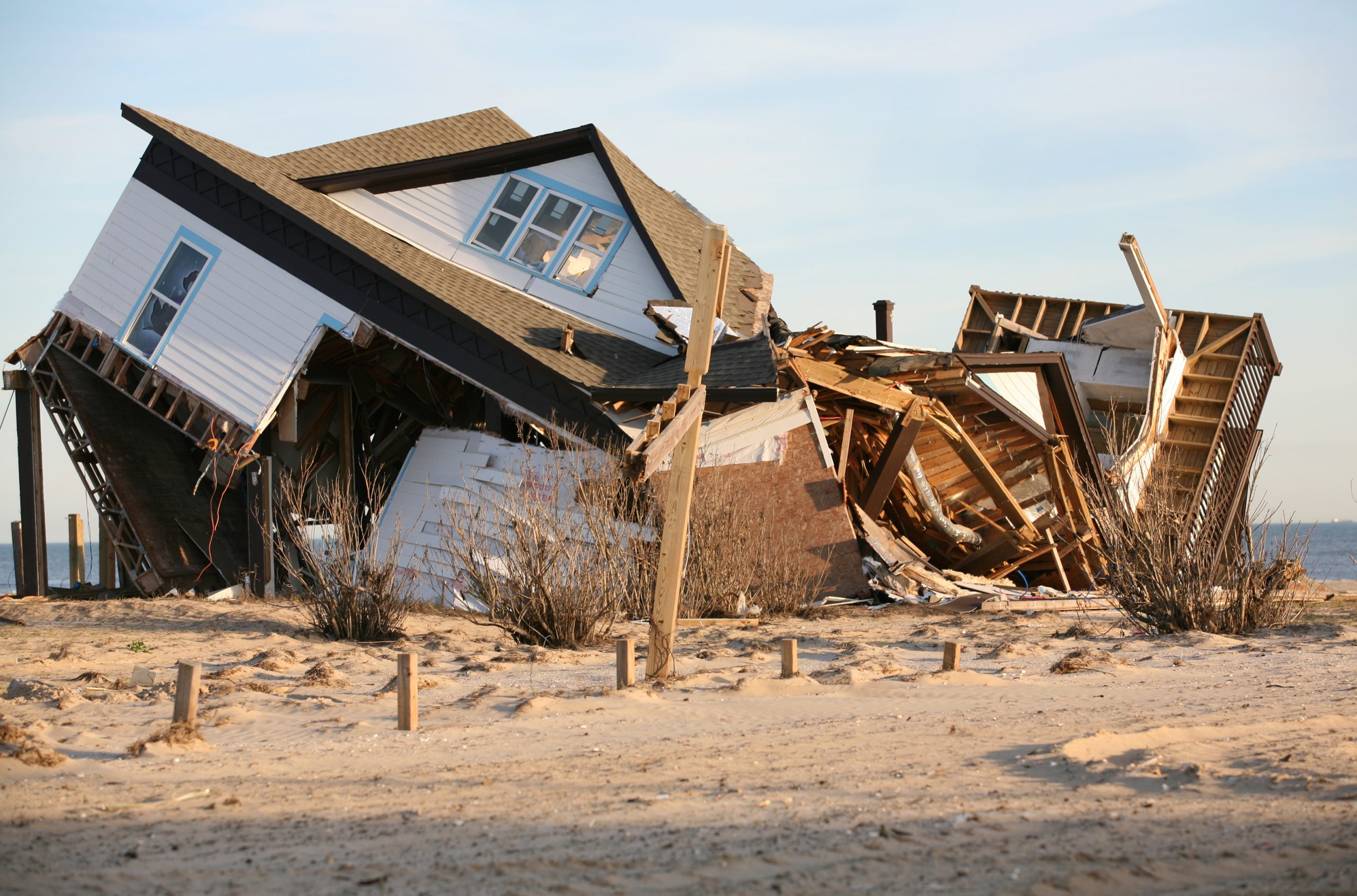 A beach house that has been severely damaged by a hurricane.