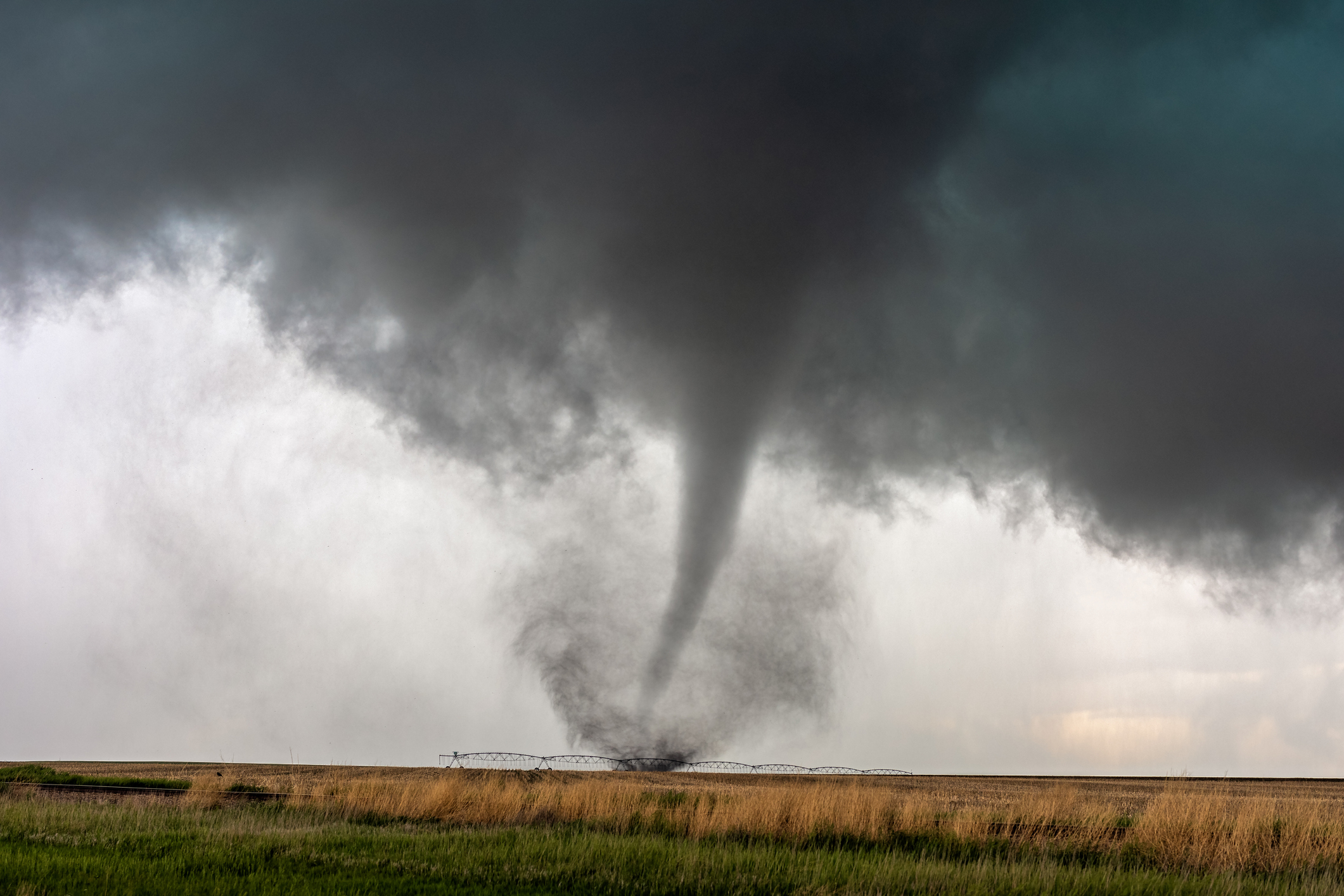 A tornado moving through a field.
