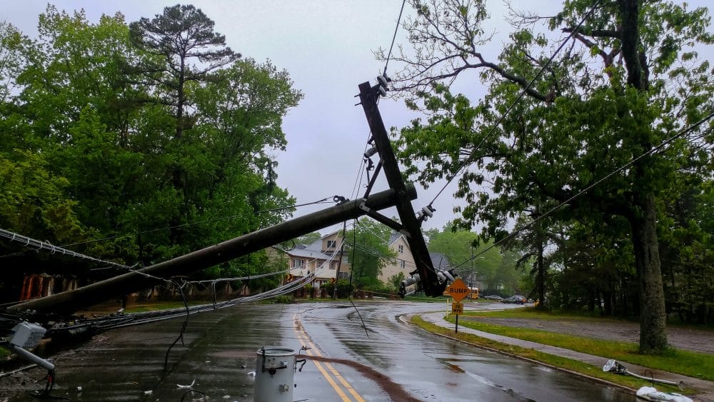 A powerline lies fallen over on the side of a road after a severe storm blew through the area.